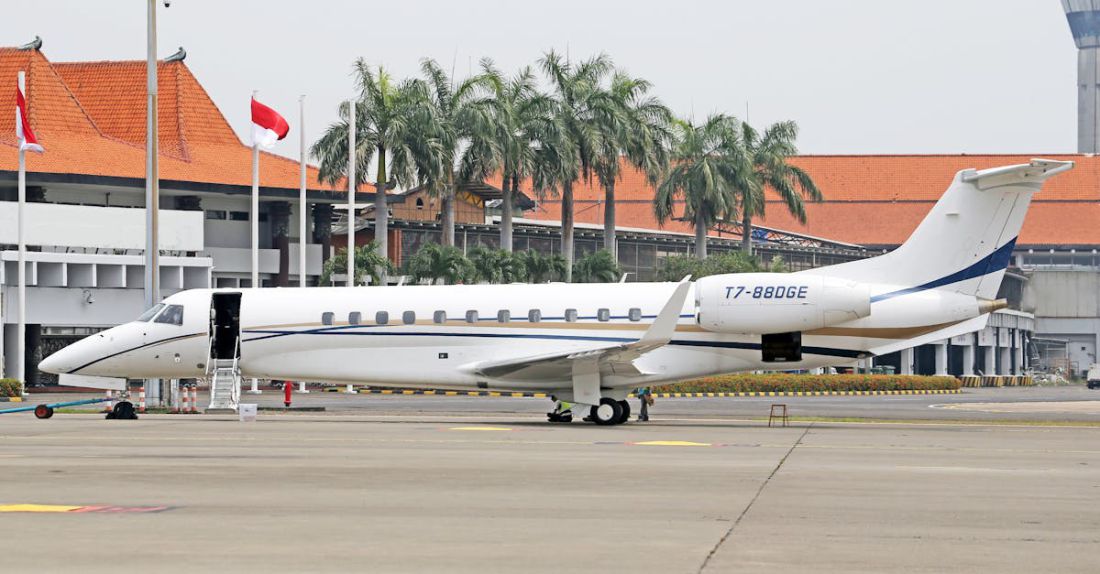 Delegation - Small Jet in Front of a Building