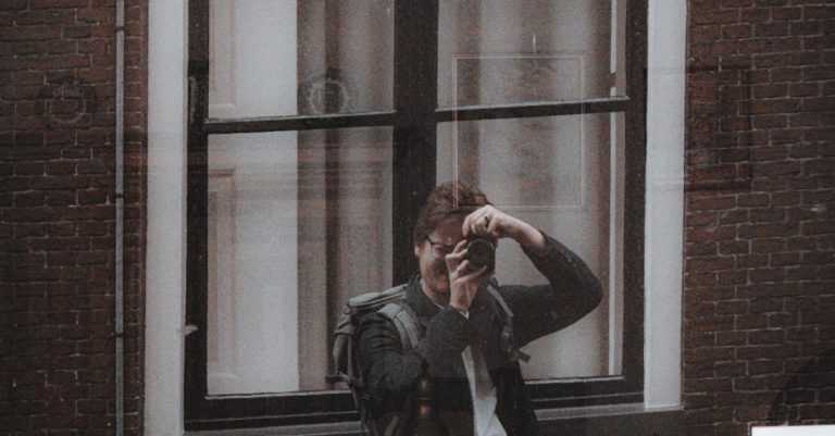 Self-Discipline - A man is taking a picture of himself in front of a window