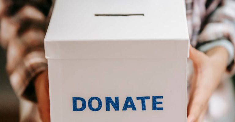 Benefits - Crop anonymous person showing donation box