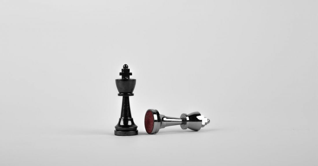 Success - Two Silver Chess Pieces on White Surface