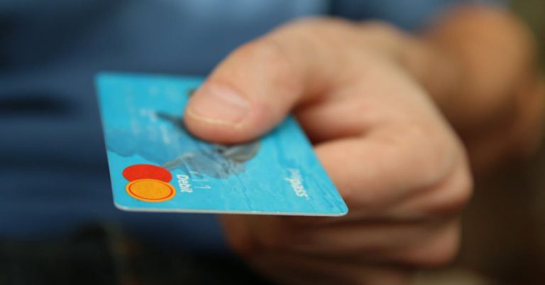 Debt - Person Holding Debit Card