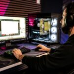 a-man-sitting-in-front-of-a-computer-with-headphones